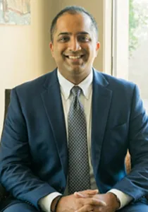 Ankur Bhargava, MD smiling in a chiropractic clinic